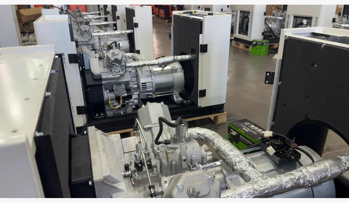Open generator enclosures exposing engines, alternators and auxiliary hardware in a workshop