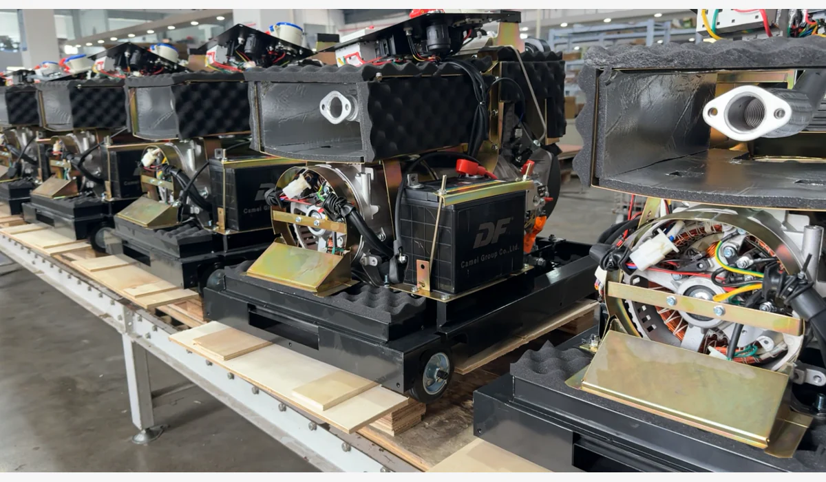 Partly assembled generator sets with engines, alternators, batteries and wiring visible on a workbench