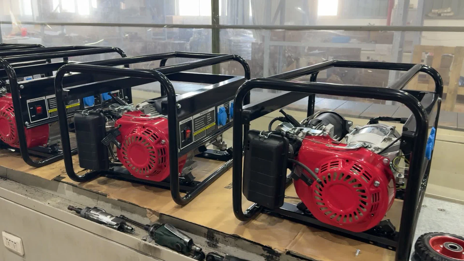 Open-frame generator units arranged on a workbench with assembly tools in view