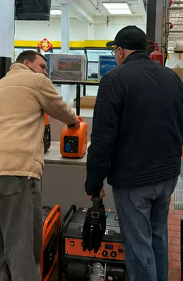 Buyer examining a compact generator at a retail display