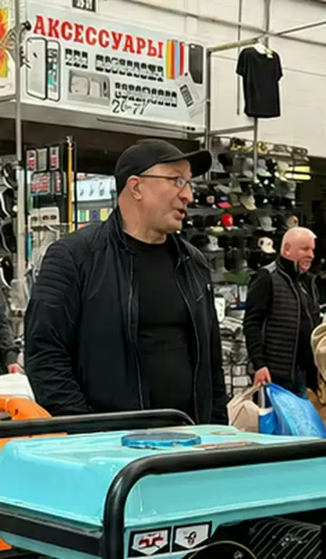 Buyer comparing generator products at an overseas retail counter