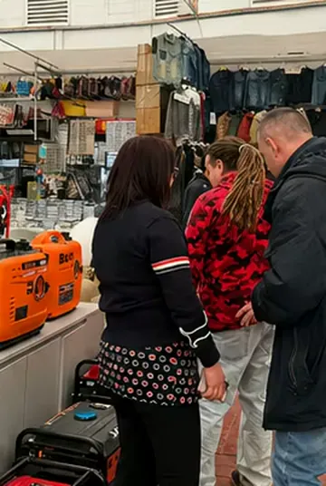 Buyers viewing compact generators at an overseas physical retail store